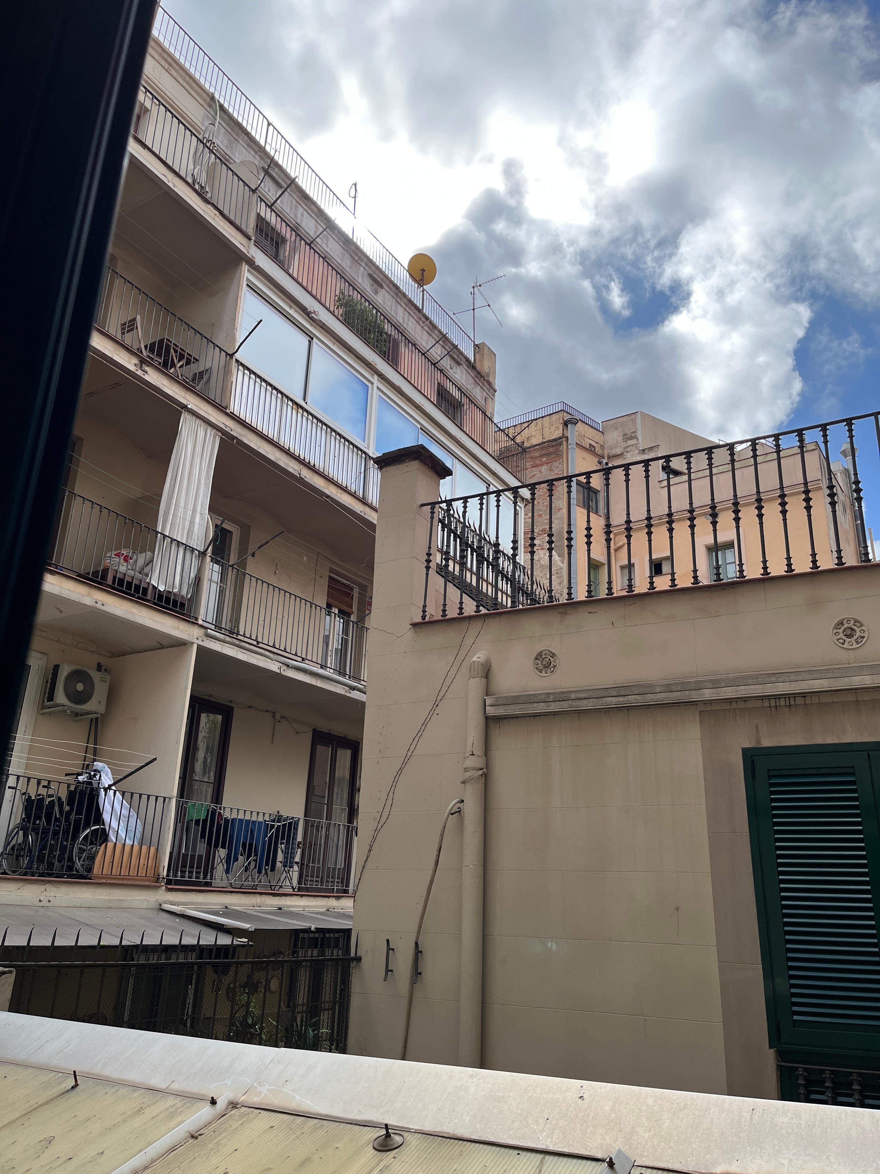 View from open window in interior room that does not face the street. Still nice to open a window. Typical European window with no screens.