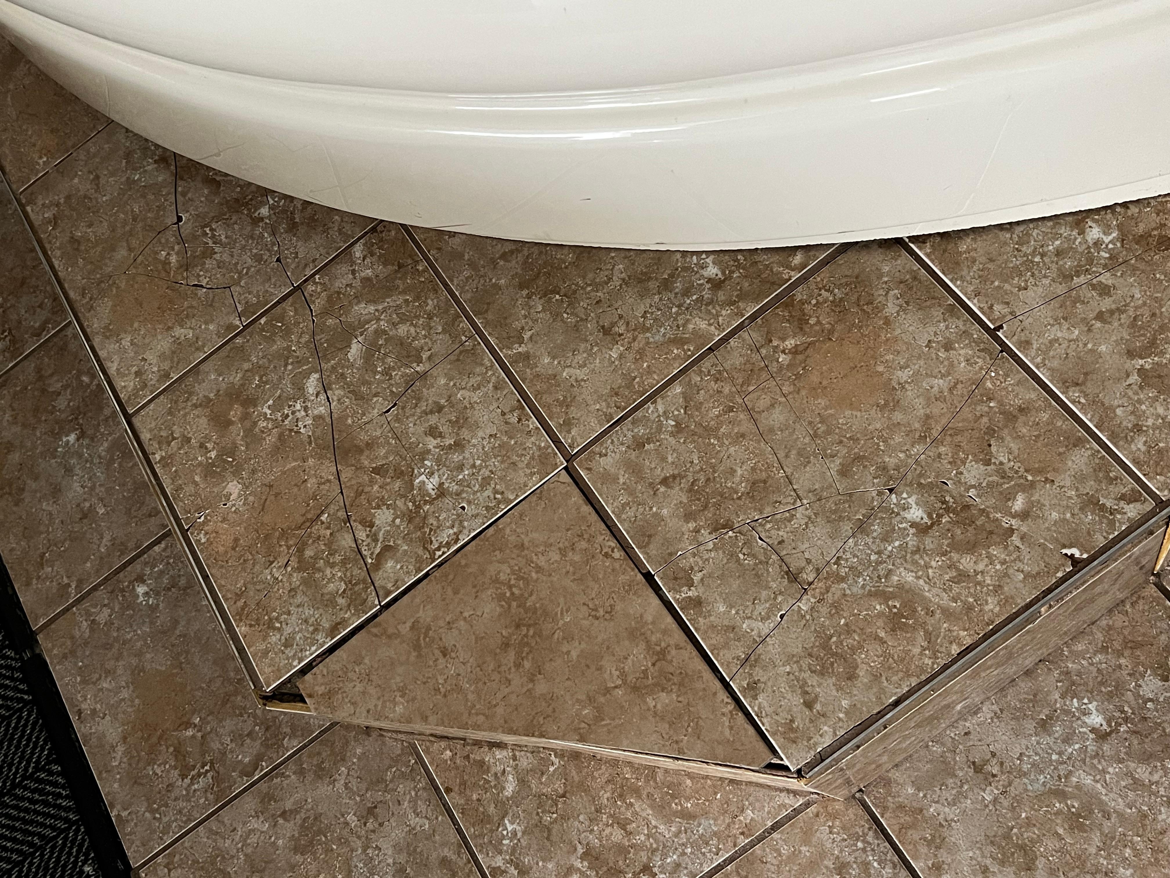 Broken tiles on jacuzzi platform.