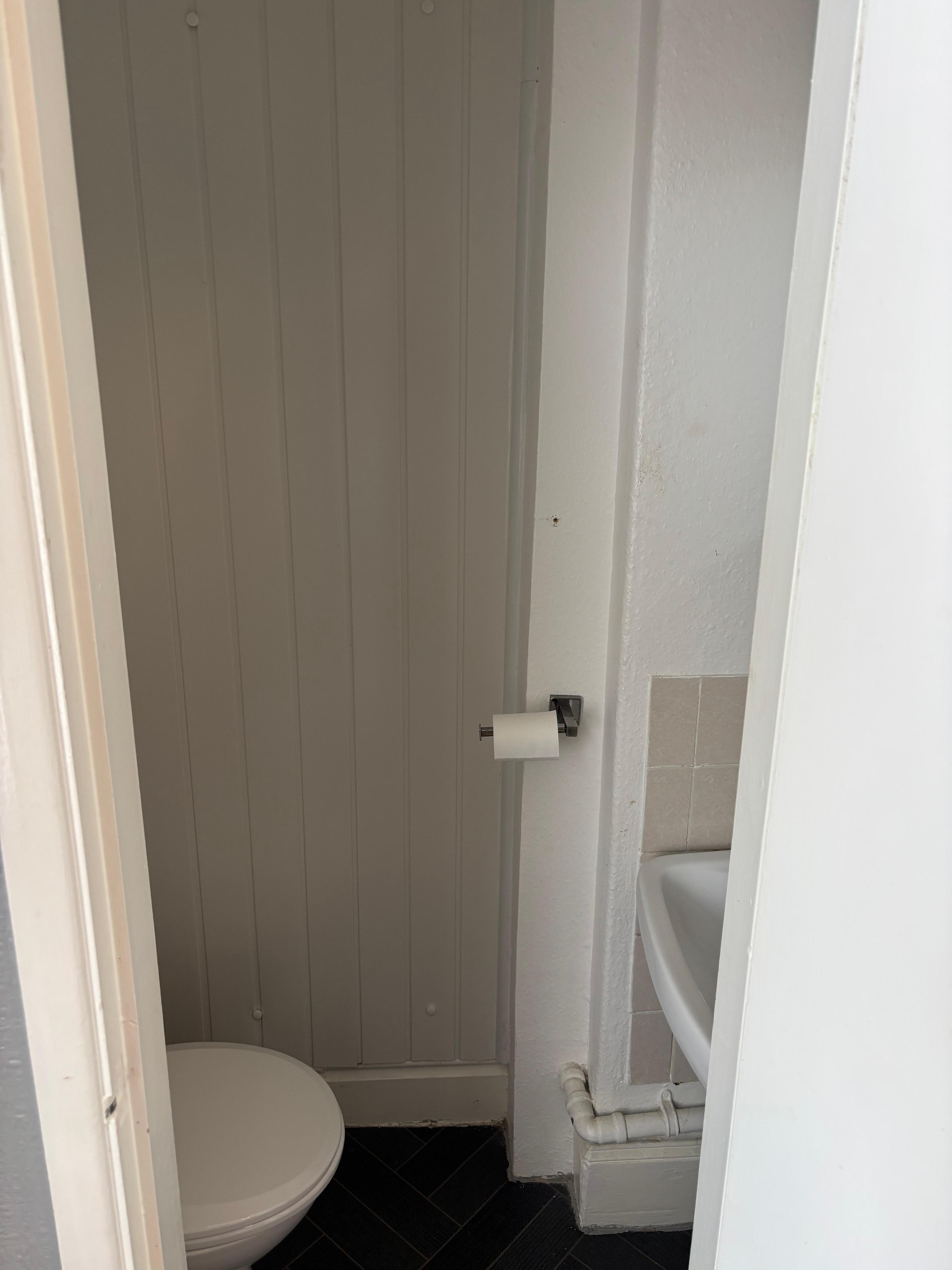 Very small room with toilet and sink