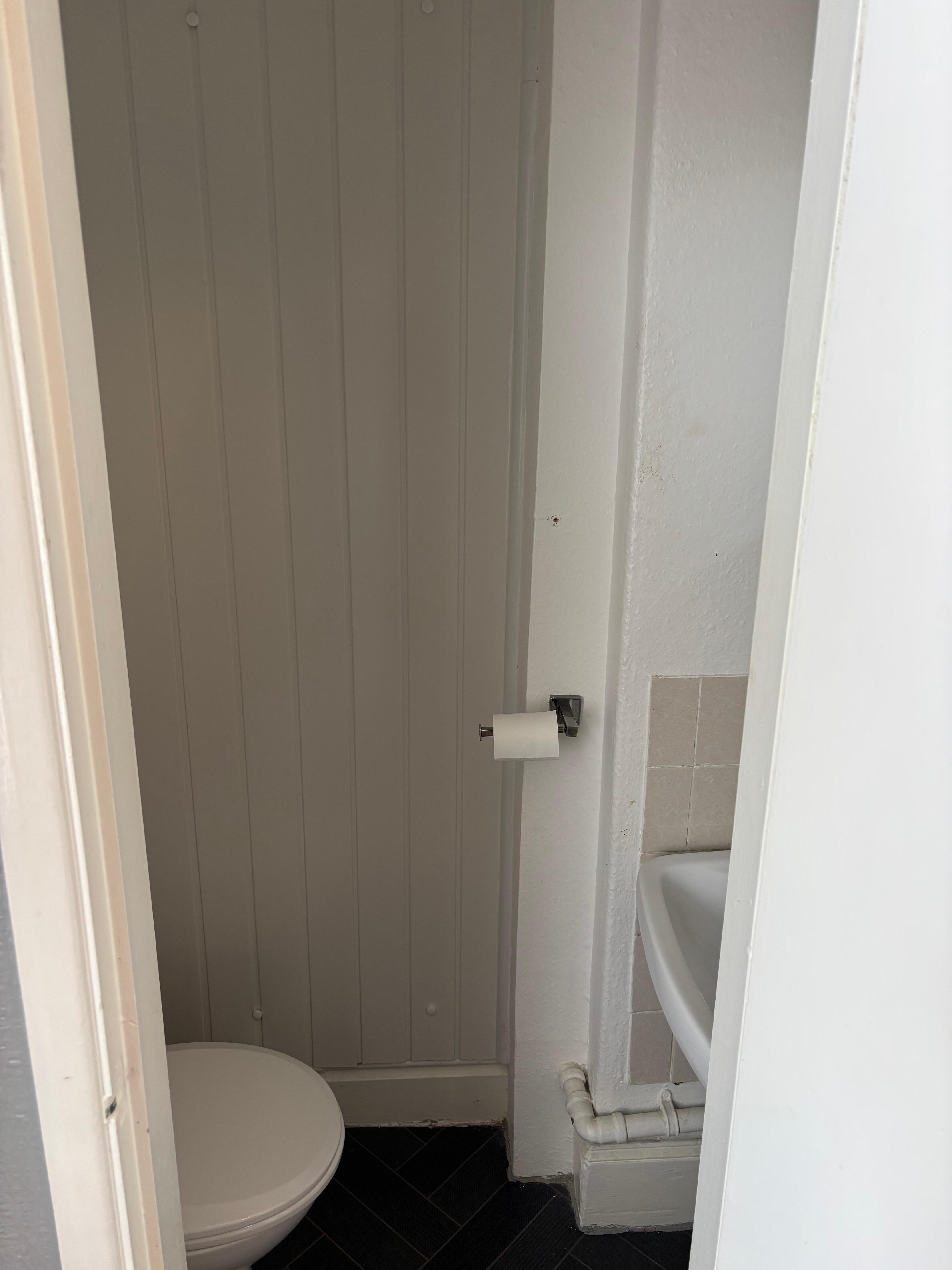 Very small room with toilet and sink