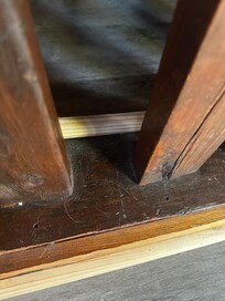 Floor corner showing accumulated dust and debris at check-in.