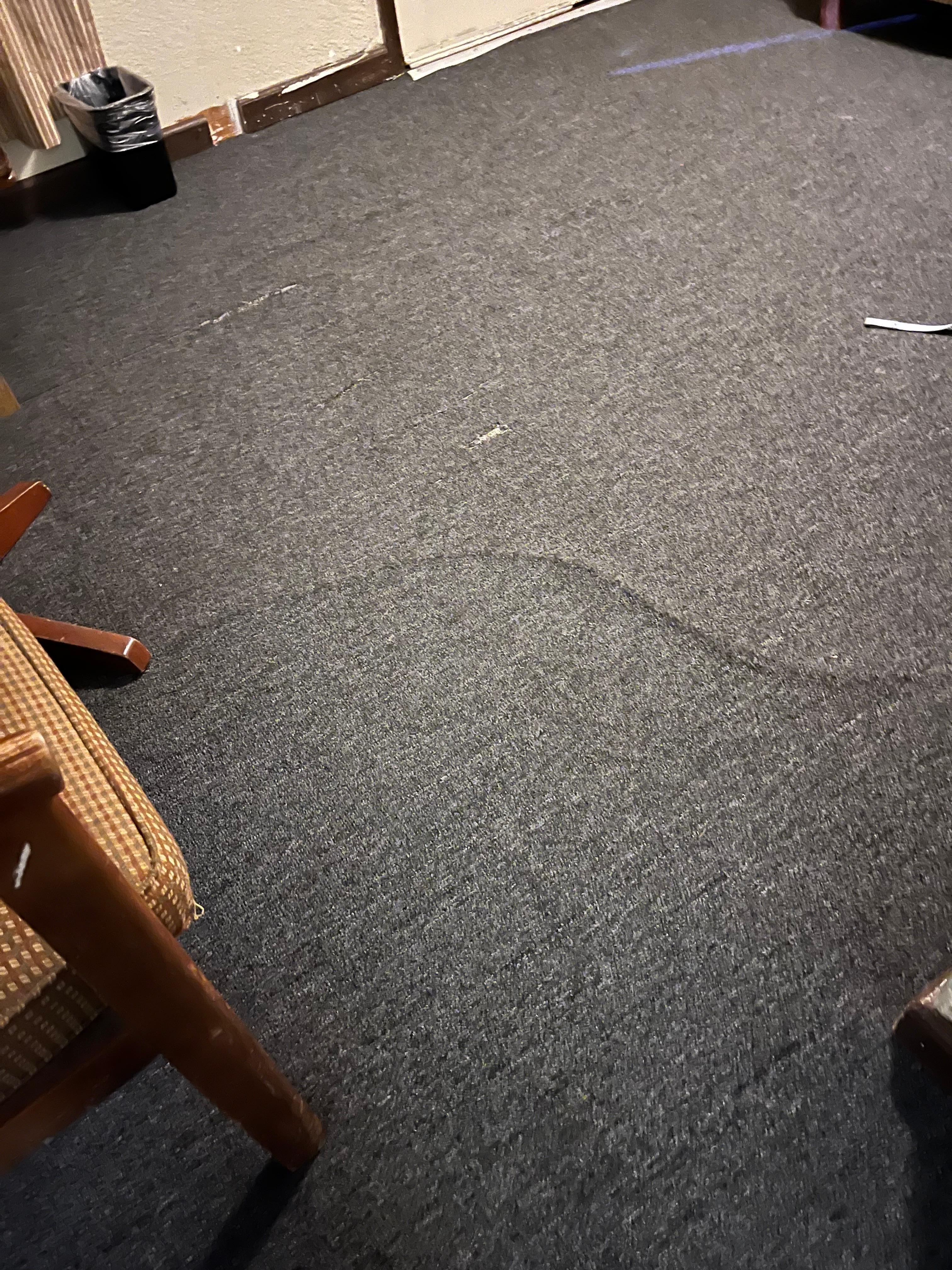 Carpet was uneven and worn.