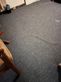 Carpet was uneven and worn.