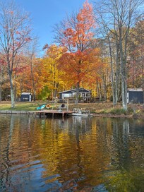 Lake view. There is a home to the left. On the right woods separate you from the next home