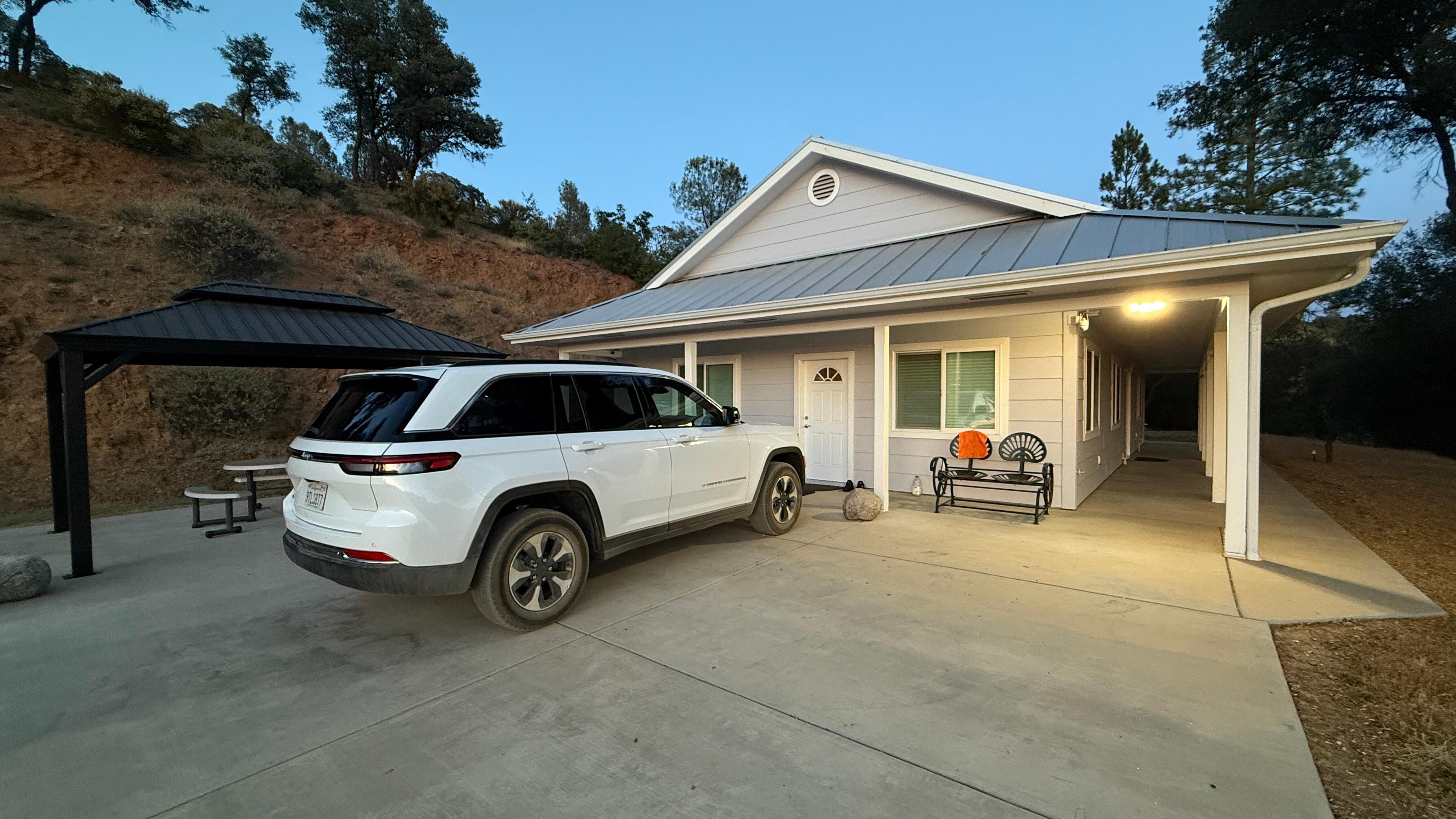 Front of the house with pergola with seating and BBQ