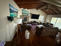Main room with AC unit in far window, inadequate to cool house; very hot in summer bc west facing