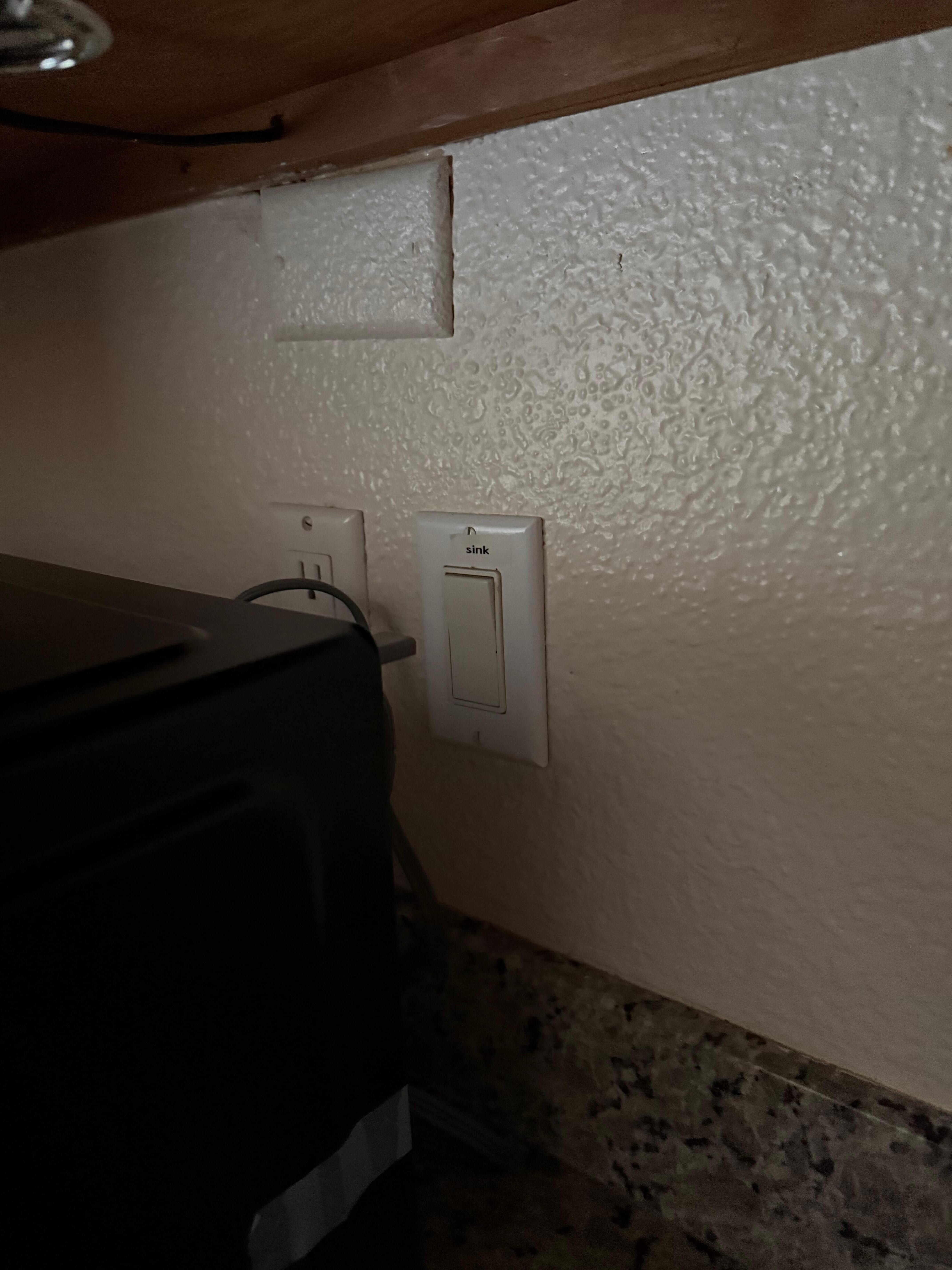 Kitchen light switch behind microwave 