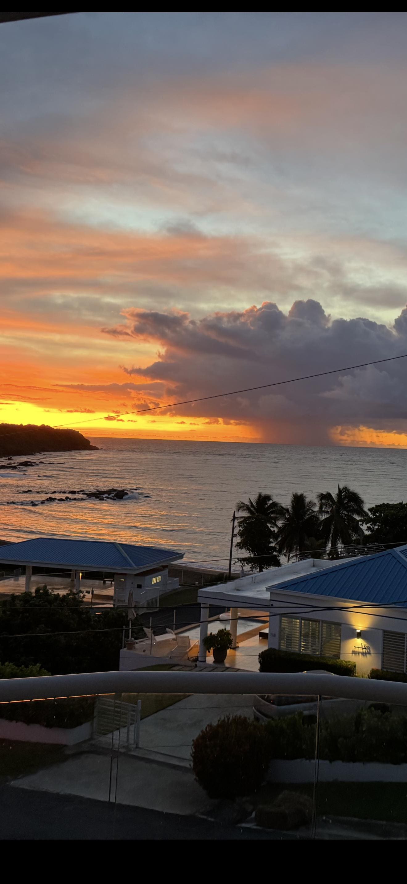 Morning sunrise with a storm cloud over the water.