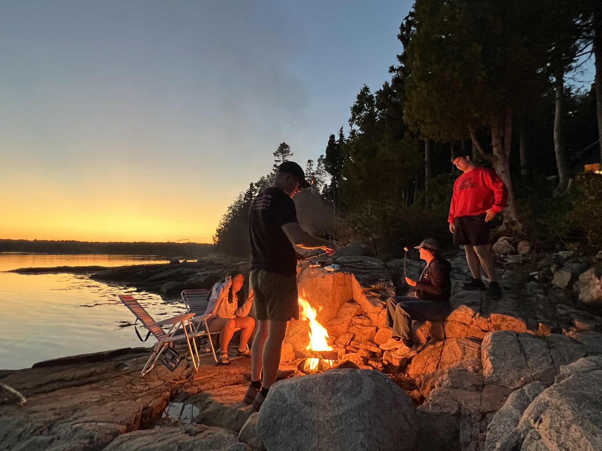 Enjoying the fire pit on the rocks by the bay