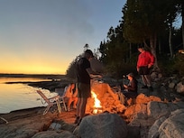 Enjoying the fire pit on the rocks by the bay