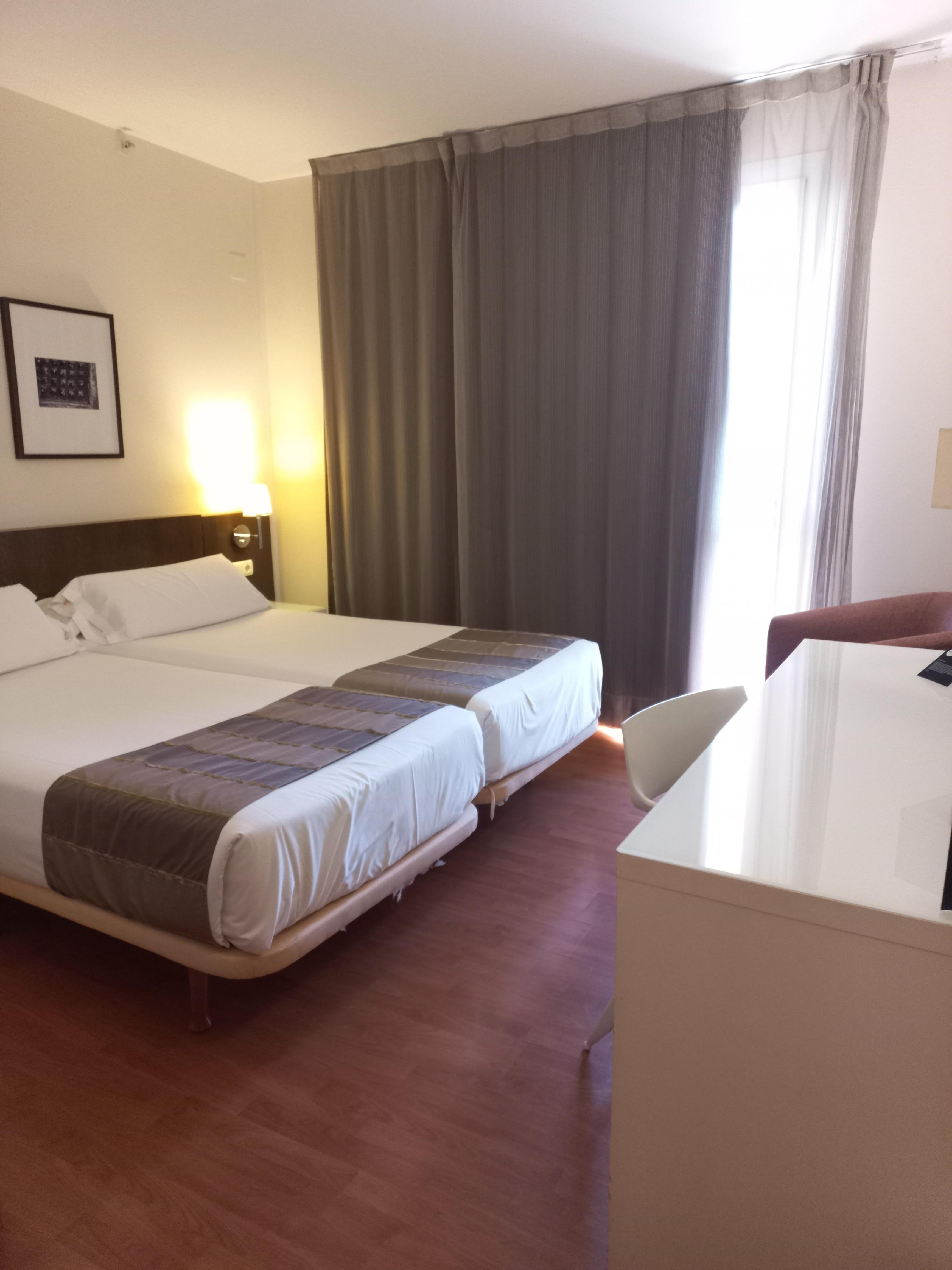 Spacious room with ample wardrobe space, mini bar and comfortable armchair.