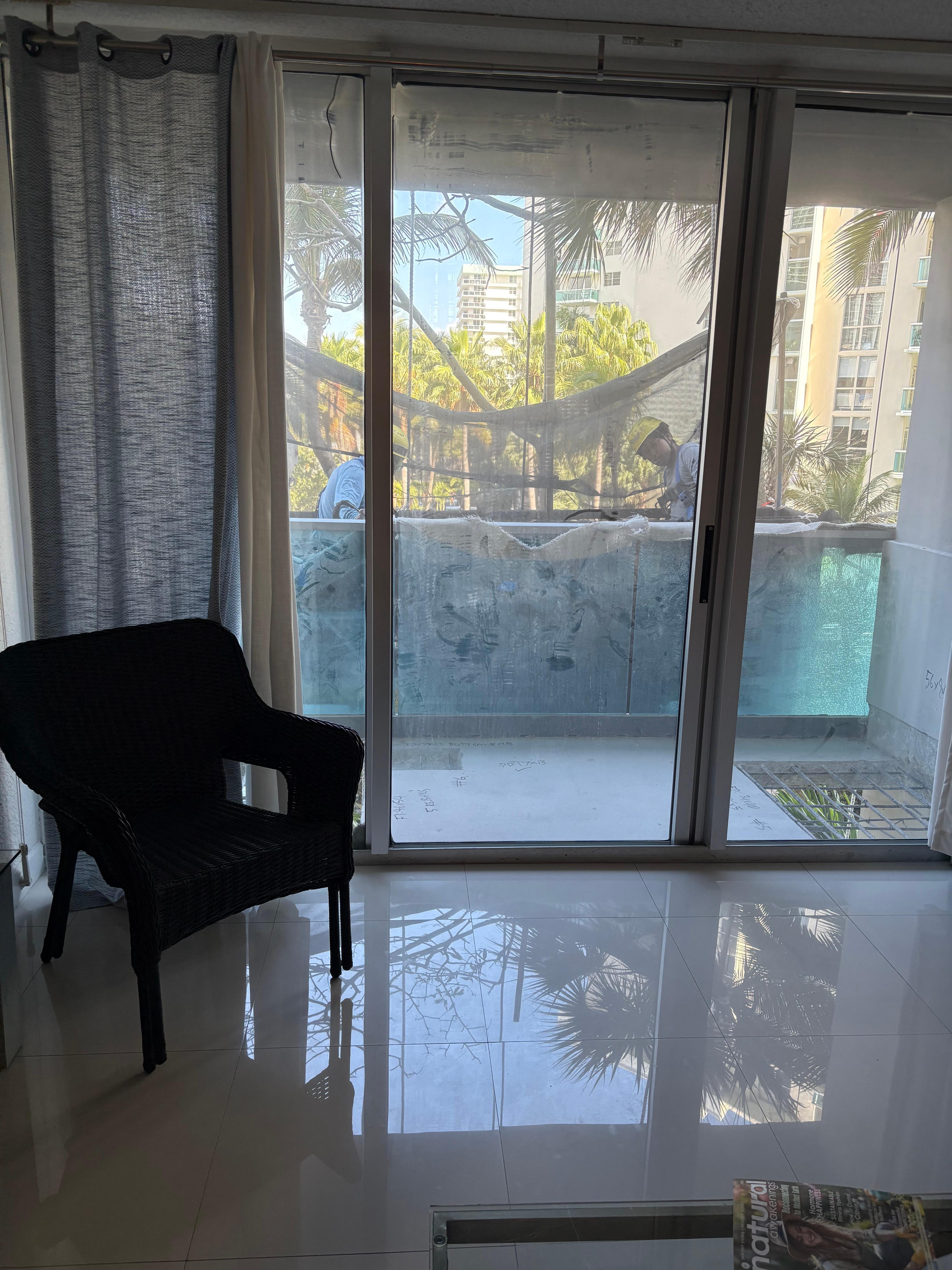 Two workers on scaffolding outside our room