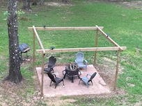 View of the fire pit, patio, and grill from the front balcony