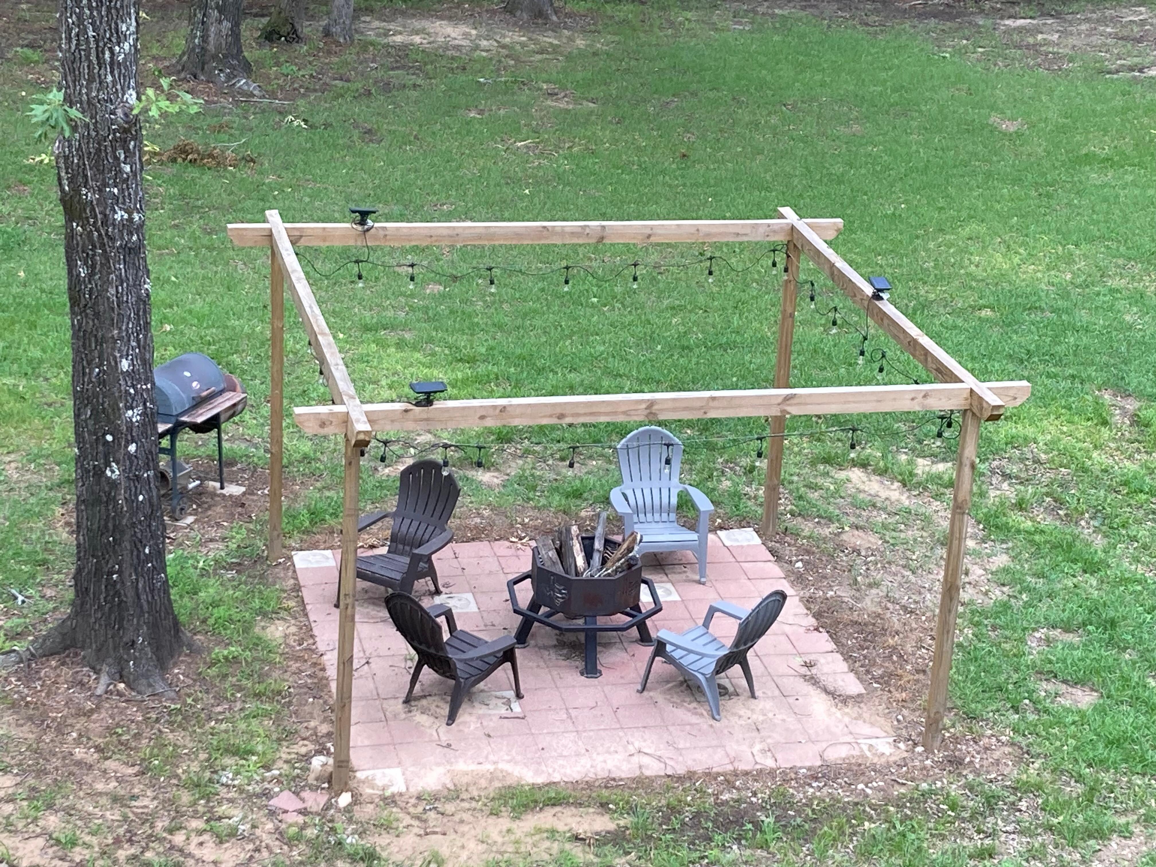 View of the fire pit, patio, and grill from the front balcony