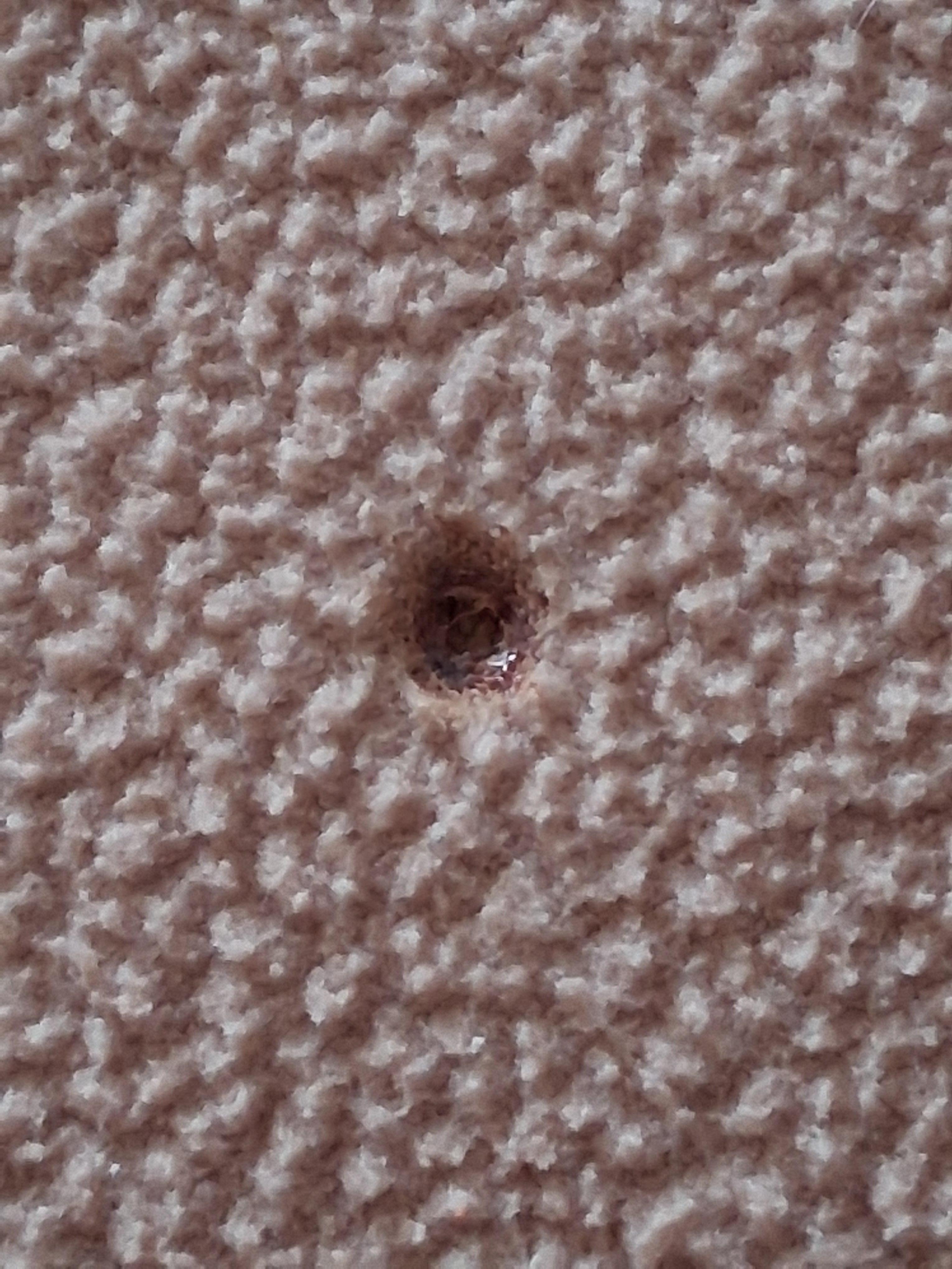 Cigarette burn in blanket in a no smoking hotel. 