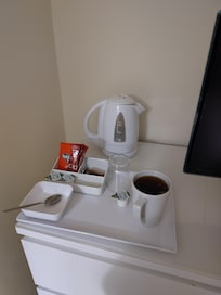 Tea and coffee station next to the telly.
