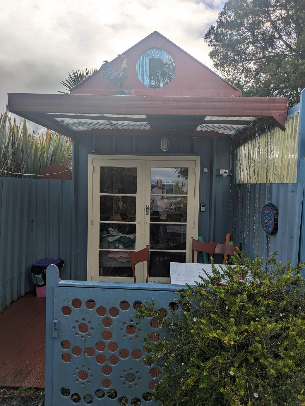 Front entrance with sheltered seating area.