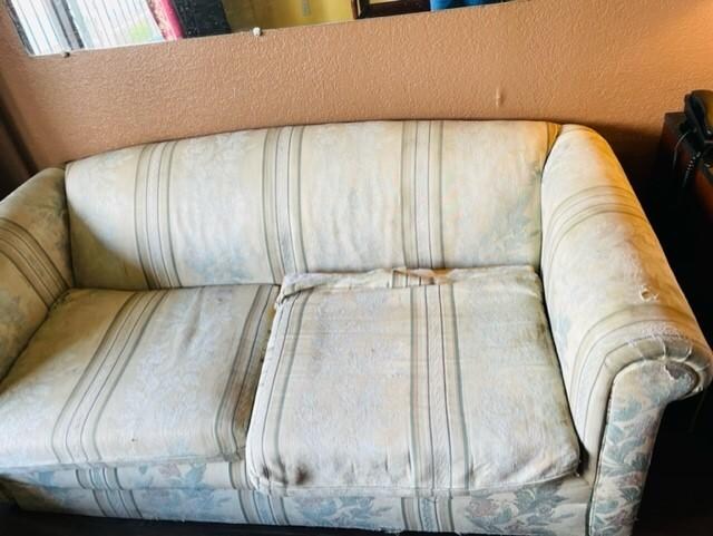 Old torn up couch in the room.