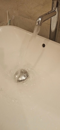 Tap water flow was not very smooth as tap faucet set is old and wear off (Room 1402).