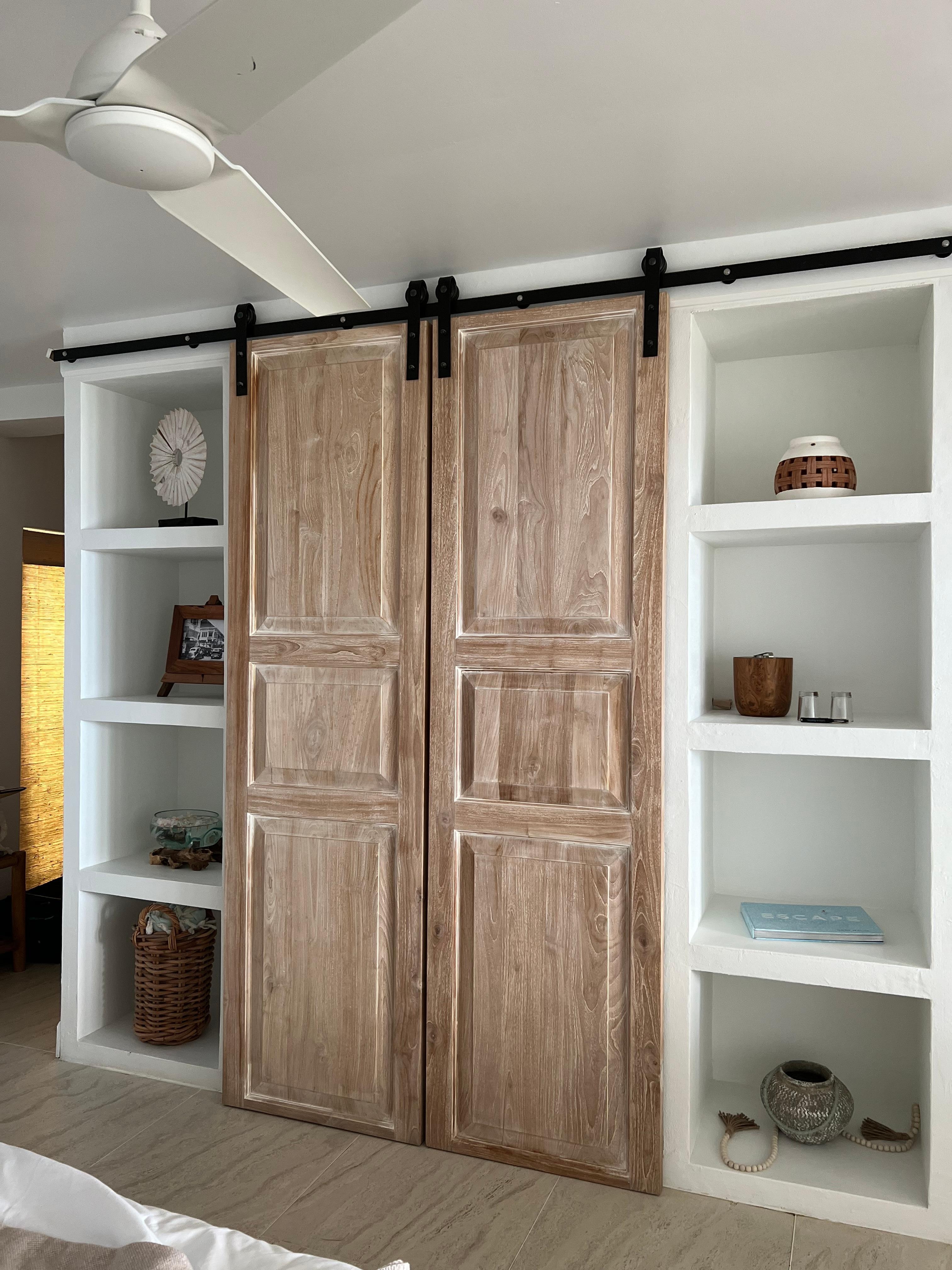 Doors hiding the television and mini fridge