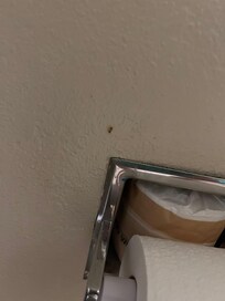 Next to toilet paper roll.