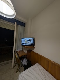 The TV stand was too small for the larger TV, TV was placed on lower shelf to left facing bathroom door.