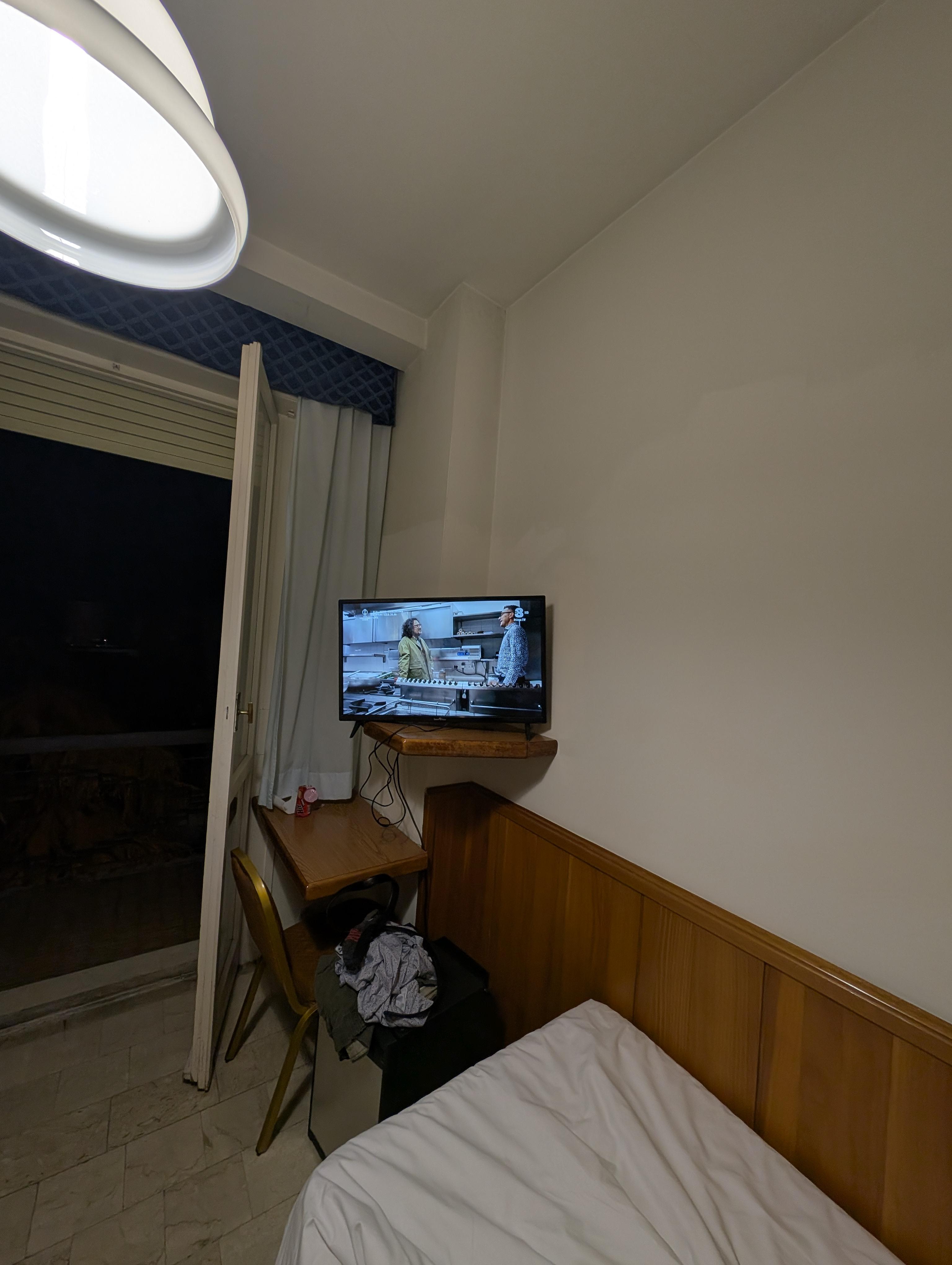 The TV stand was too small for the larger TV, TV was placed on lower shelf to left facing bathroom door. 