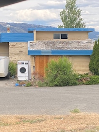 Broken laundry equipment near front of building check in area