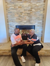 In front of their fireplace in the lobby