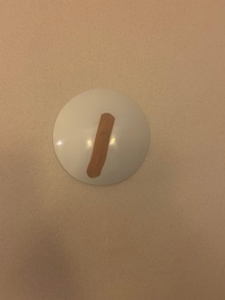 The bandaid that was on the wall when we first walked in our room.