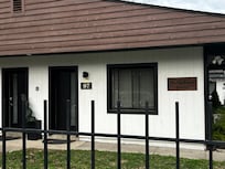 Front with trash around the gate.