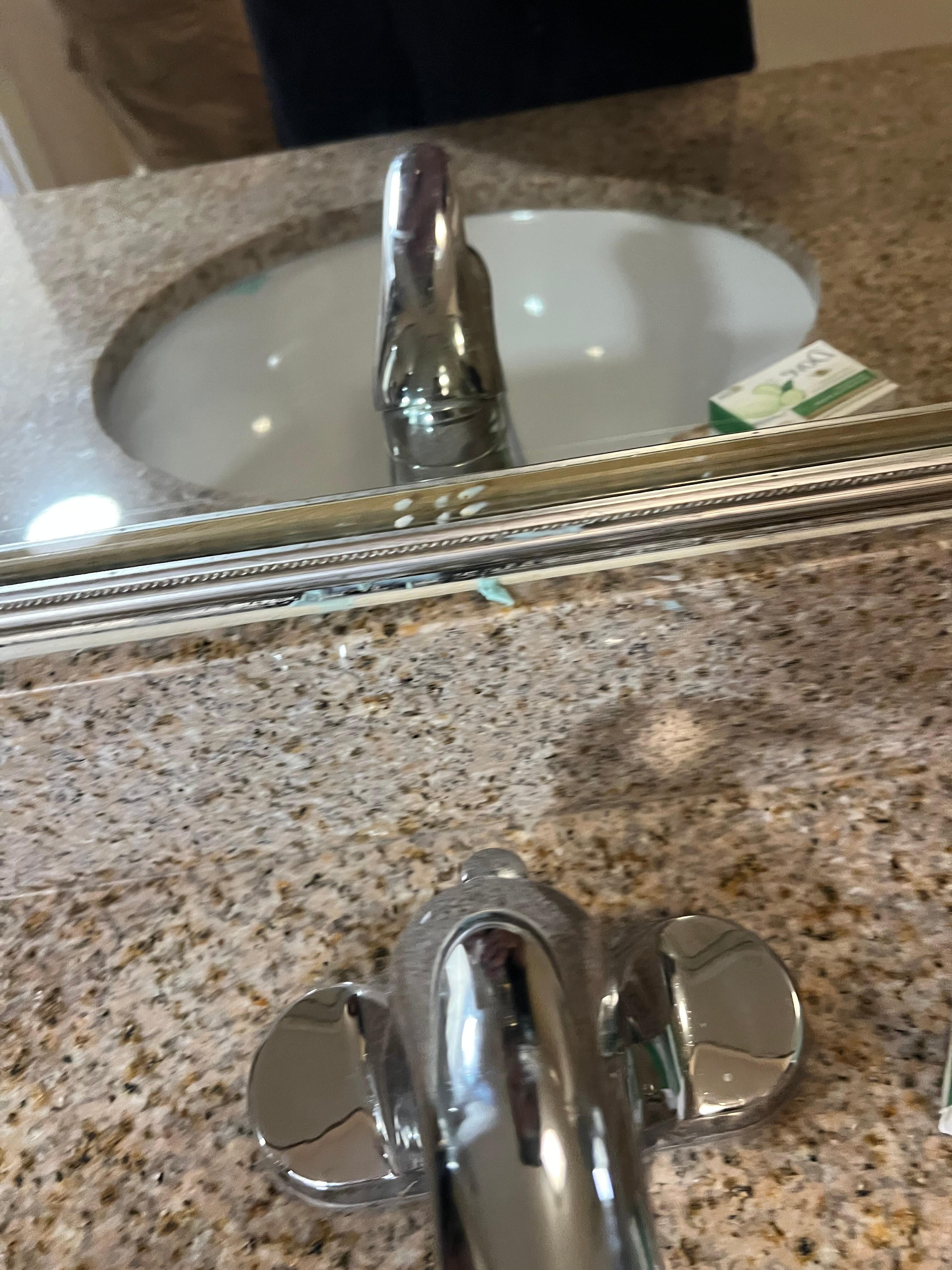 Toothpaste on sink and mirror