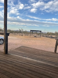 Looking off front porch. Nice table and chairs to enjoy the fresh air