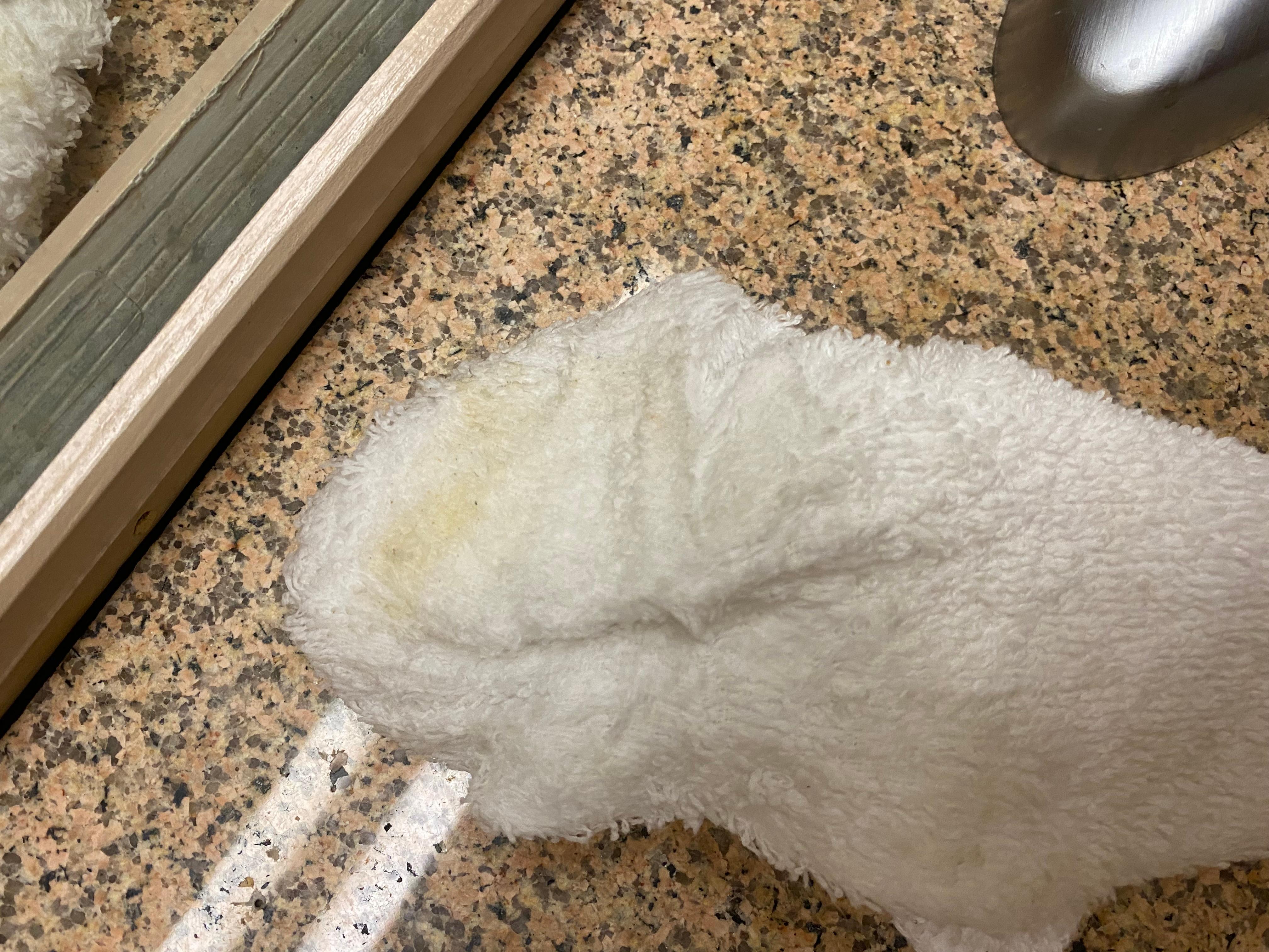 The residue from toilet seat on rag