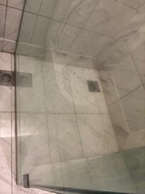 shower screens are all covered in a layer of soap scum