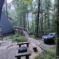 No covered carport as shown on listing. Weathered, insect damaged fire pit area with different fire pit.