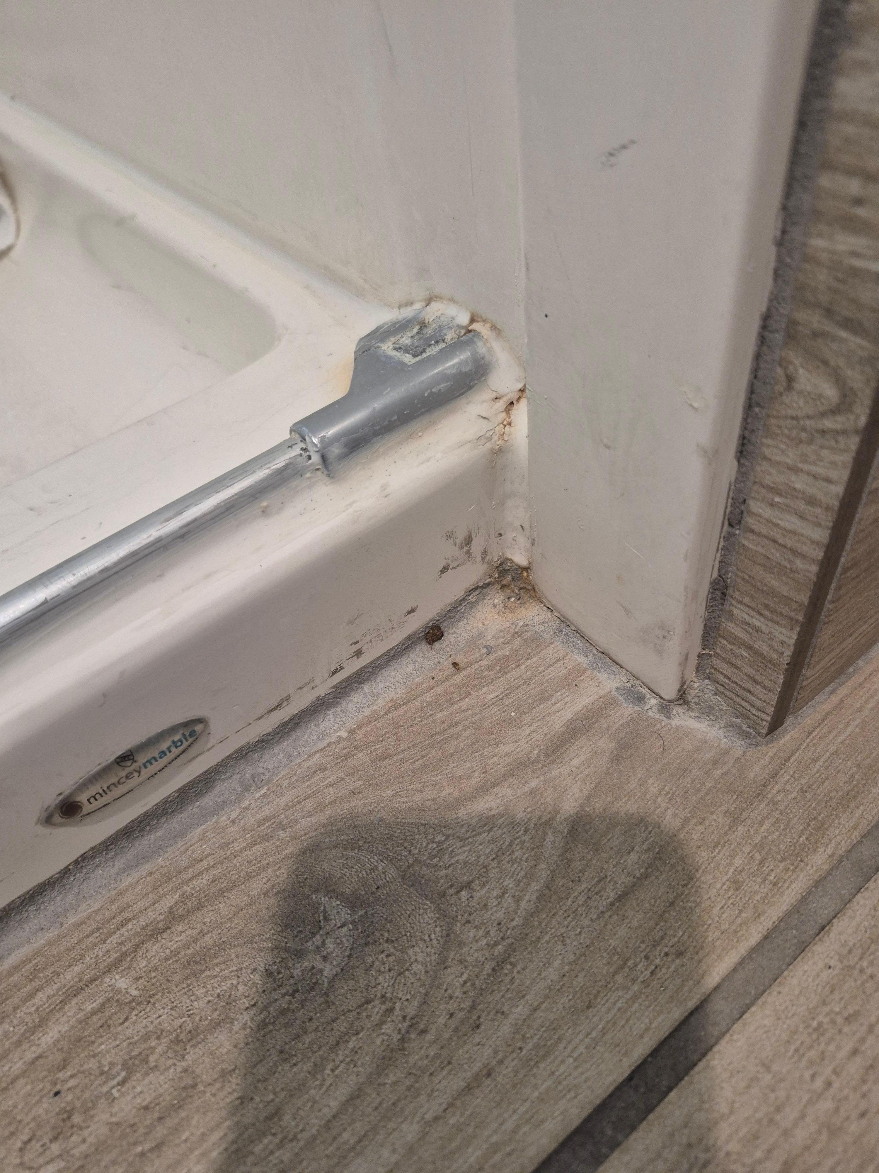 Dirty bathroom floor by shower