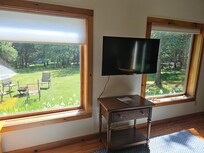 Huge picture windows onto beautiful yard