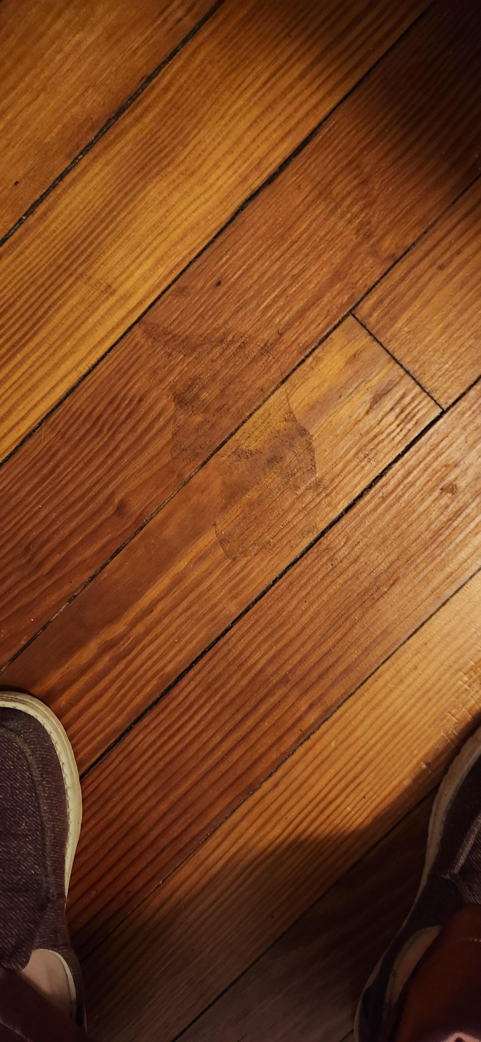 Sticky stuff on floor next to bed. 