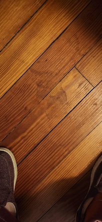 Sticky stuff on floor next to bed.