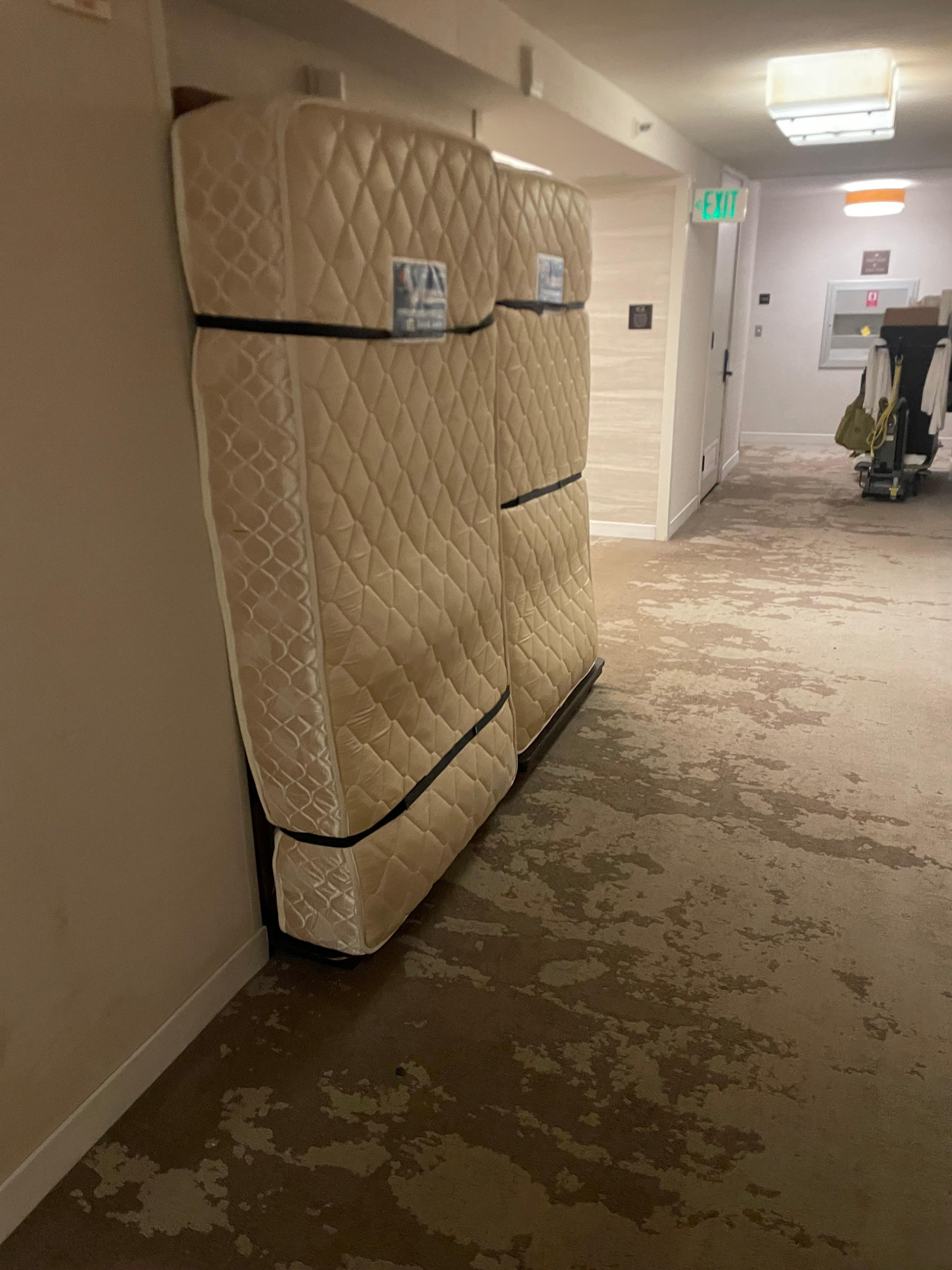 Paying an extra $200 for “amenities” must also include having dirty mattresses strapped to the wall directly outside your hotel door. 