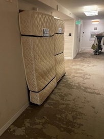 Paying an extra $200 for “amenities” must also include having dirty mattresses strapped to the wall directly outside your hotel door.