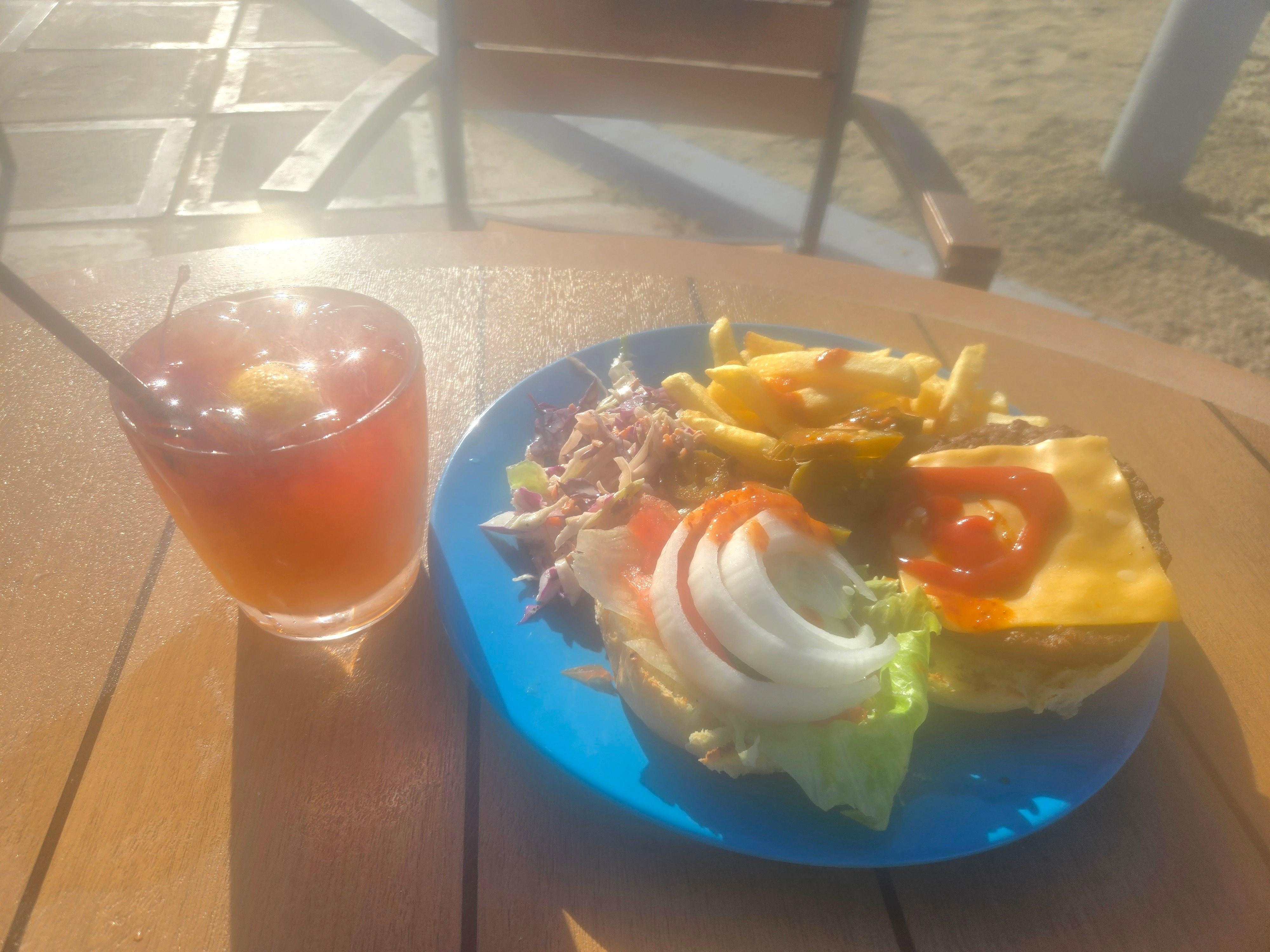 Eating a meal at the poolside with cocktail drink 