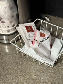 Opened packet by tiny coffee pot.