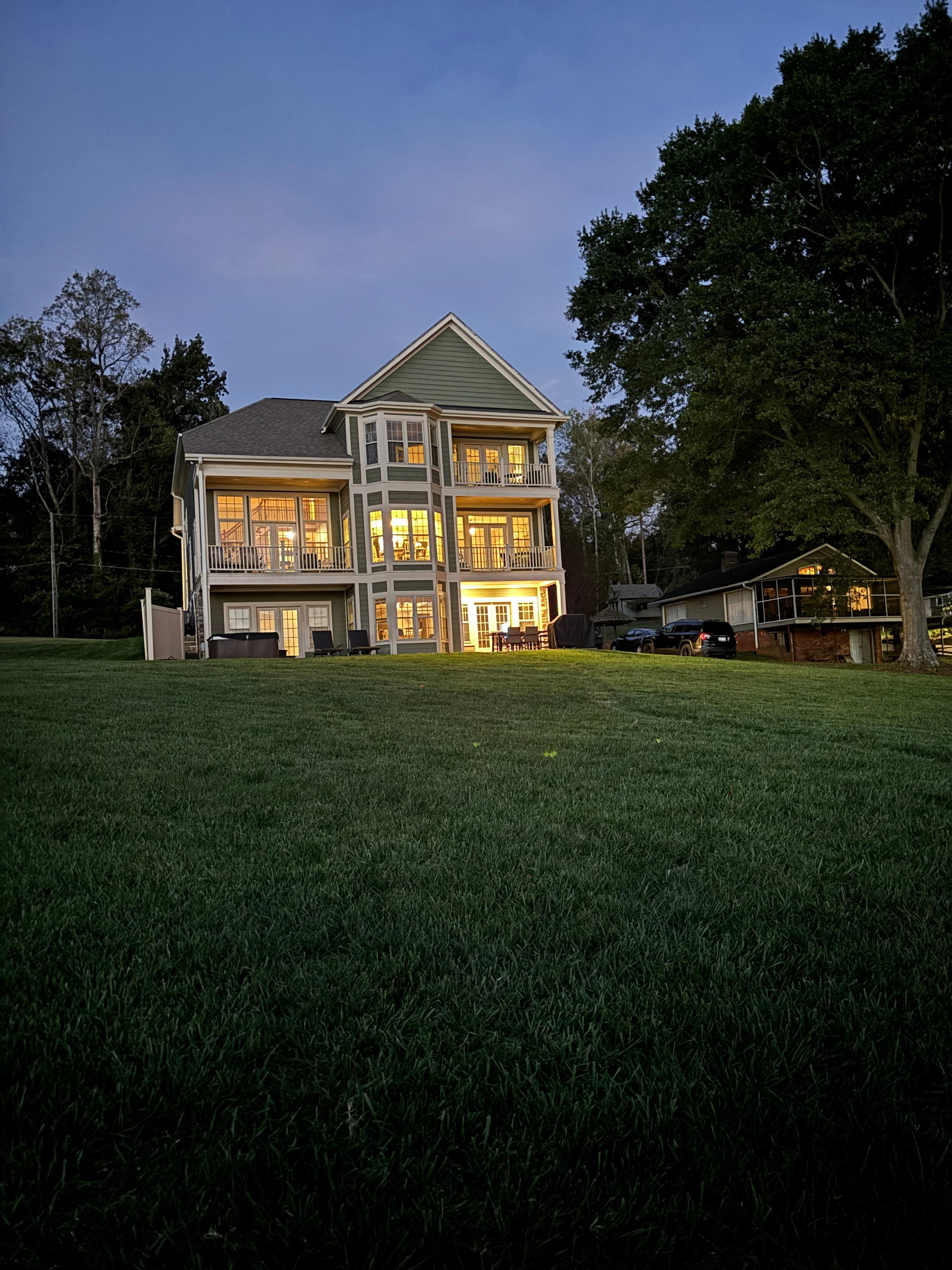 Looking up at the house from the lakeside fire pit and Adirondack chairs
