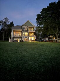 Looking up at the house from the lakeside fire pit and Adirondack chairs