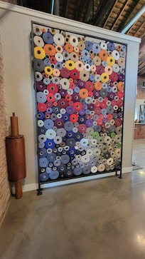 Yarn spools in the lobby from the mill