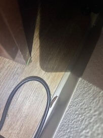 On the floor between the bed and the night stand