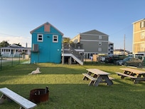 Huge deck and fenced yard with picnic tables, fire pit