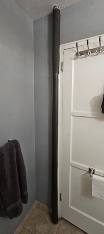 Pool noodle covering a pipe in the bathroom